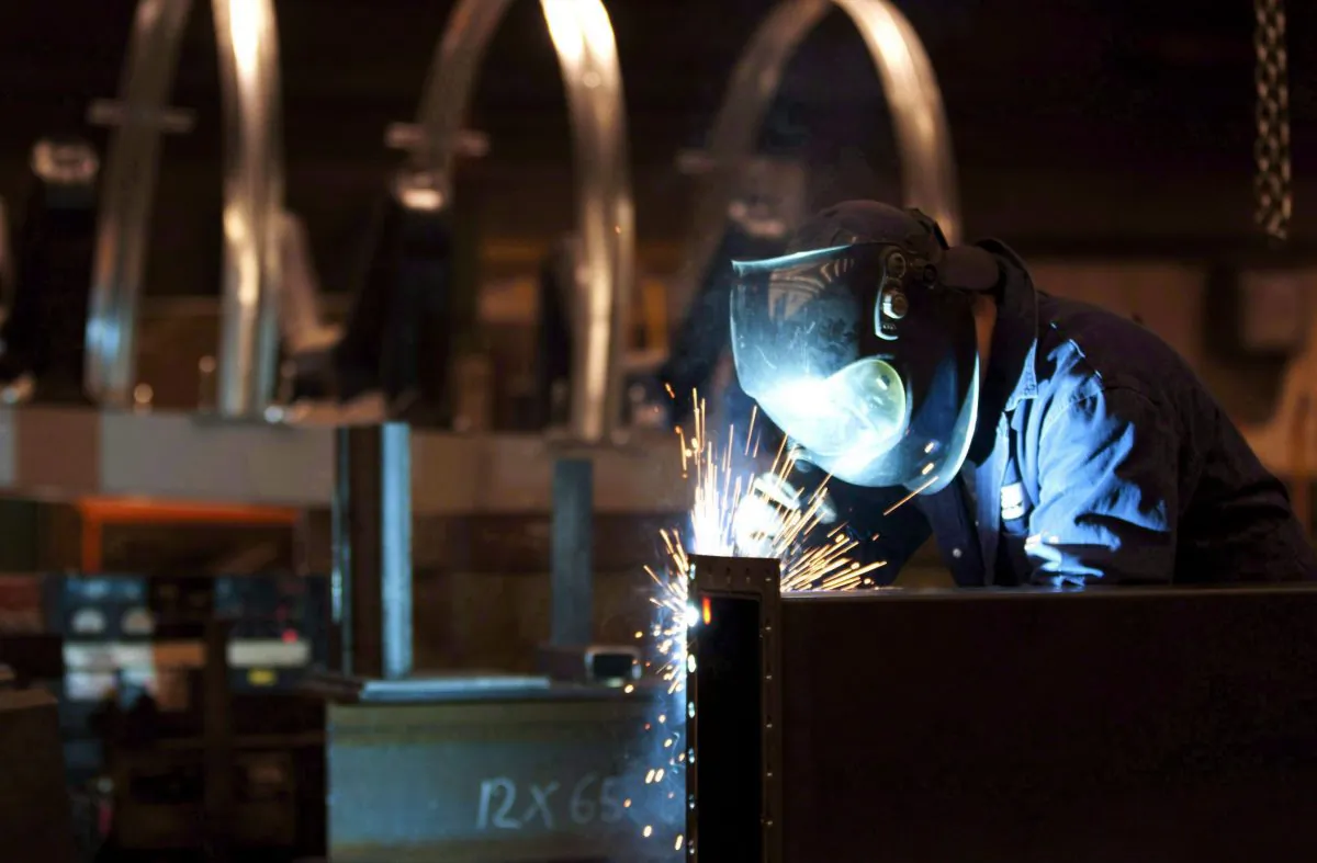 A welder works in a factory in Quebec City in this file photo. Manufacturing advanced 0.6 percent in July. (The Canadian Press/Jacques Boissinot)