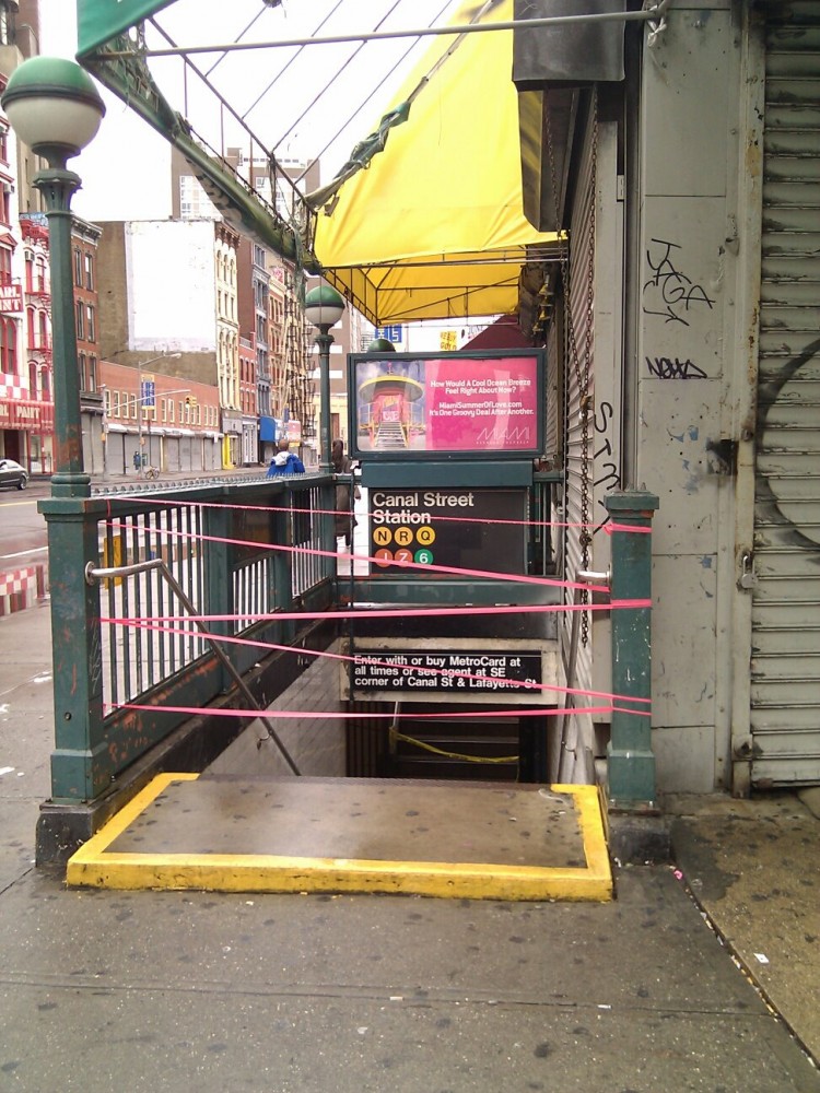 Red ribbons block the entrance to Canal Street Station in Lower Manhattan on Sunday morning. The MTA said if any services resume, the first will be the bus service. (Vicky Jiang/The Epoch Times)