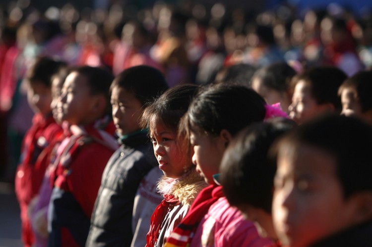 BEIJING, CHINA - DECEMBER 28: Students gather on the playground at Xingzhi Primary School, one of the largest migrant children's schools, on December 28, 2004 in Beijing, China.  (Photo by Cancan Chu/Getty Images)