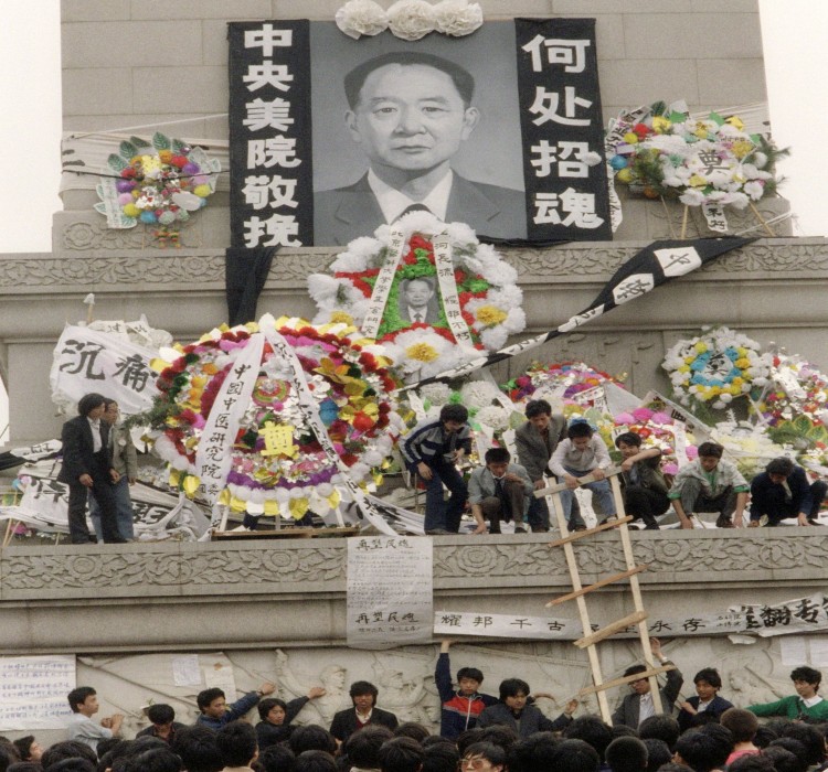 Beijing students put flowers and wreaths in front Epoch Times Photo