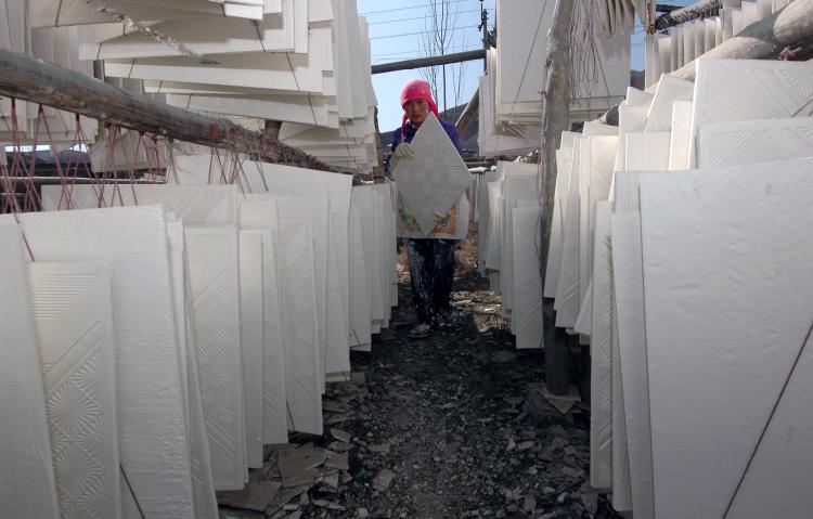 DRYWALL: A villager works at her plasterboard workshop in 2005 in Huzhu County of Qinghai Province, China. (China Photos/Getty Images) DRYWALL: A villager works at her plasterboard workshop in 2005 in Huzhu County of Qinghai Province, China. (China Photos/Getty Images)