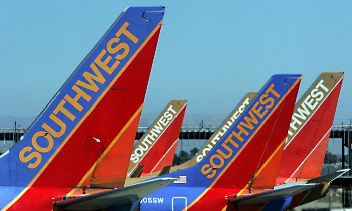 The tail sections of Southwest Airlines planes are seen at the Oakland International Airport in this file photo from 2005. Southwest, along with other airlines, entered into derivative financial contracts to hedge, or lock in, a certain price for aircraft fuel intending to offset the volatile nature of fuel prices. (Justin Sullivan/Getty Images)