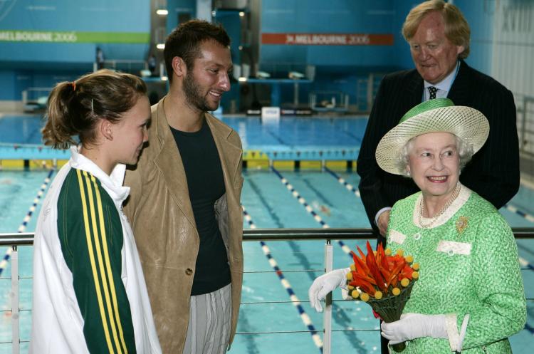 Queen Elizabeth II chats with Australian swimmers Kylie Palmer (L) and Ian Thorpe (2nd L) as Ron Walker, chairman of the Commonwealth Games Corp., looks on. The Queen, who was in Australia on a five-day visit, opened the 18th Commonwealth Games on March 1, 2006. (Rick Rycroft-Pool/Getty Images)