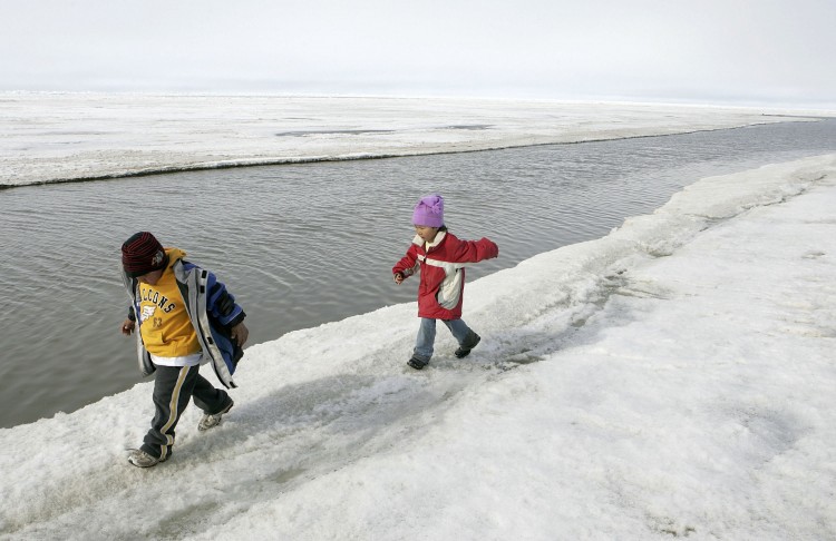 Inupiat eskimo children play along the banks of the frozen Arctic Ocean June 7, 2006 in Browerville, Alaska. (Justin Sullivan/Getty Images) Epoch Times Photo
