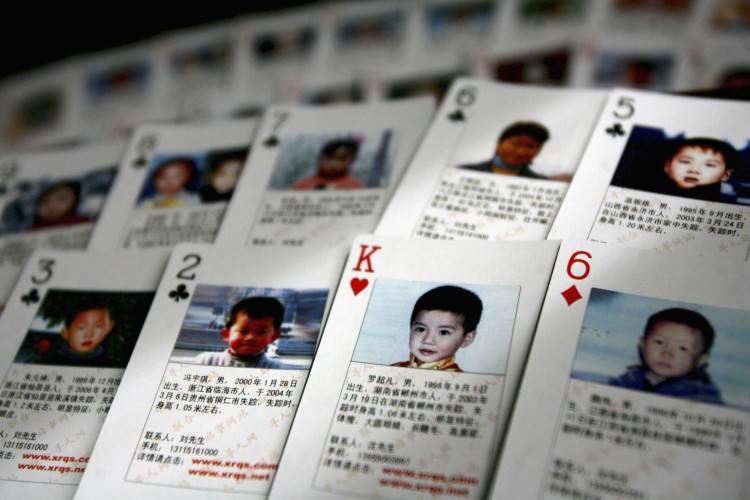 BEIJING, CHINA: The "missing children playing cards" are displayed by Shen Hao, the founder of a missing person website, the www.xrqs.com, on March 31, 2007 in Beijing, China. The cards show photographs, informations of 27 missing children and Shen Hao plans to hand out them free to the public security departments, civil affairs bureaus and residents, in areas notorious for child trafficking.