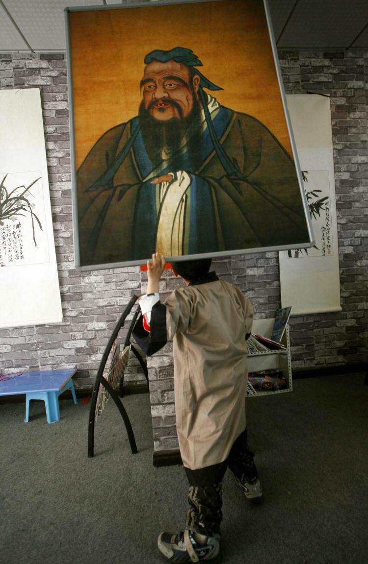 A Chinese boy looks at an image of Confucius, the ancient Chinese philosopher. (Liu Jin/AFP/Getty Images)