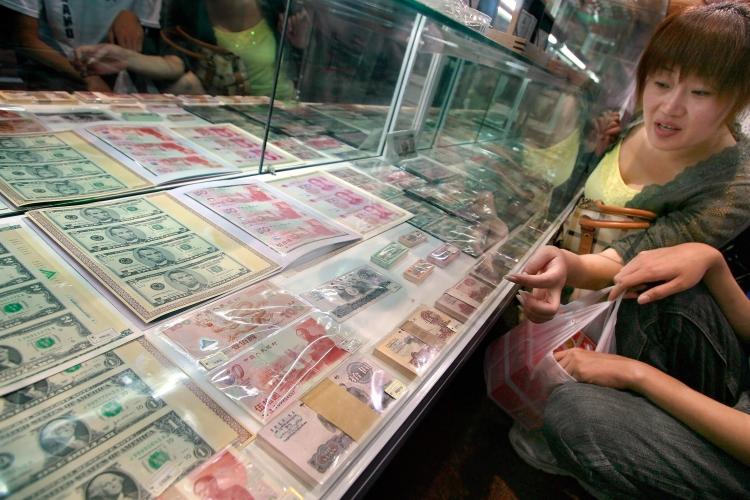 U.S. dollar bills and Chinese yuan notes at a currency souvenir shop in Beijing. China has huge forex reserves that are causing concern in the U.S. (Teh Eng Koon/AFP/Getty Images) U.S. dollar bills and Chinese yuan notes at a currency souvenir shop in Beijing. China has huge forex reserves that are causing concern in the U.S. (Teh Eng Koon/AFP/Getty Images)