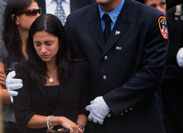 Linda Graffagnino is escorted by a New York firefighter Linda Graffagnino is escorted by a New York firefighter