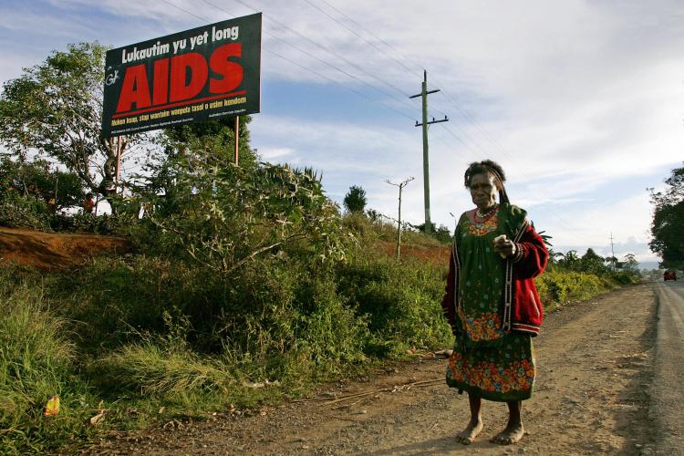 A woman walks past a anti-AIDS billboard in Mount Hagen. (Anoek De Groot/AFP/Getty Images) A woman walks past a anti-AIDS billboard in Mount Hagen. (Anoek De Groot/AFP/Getty Images)