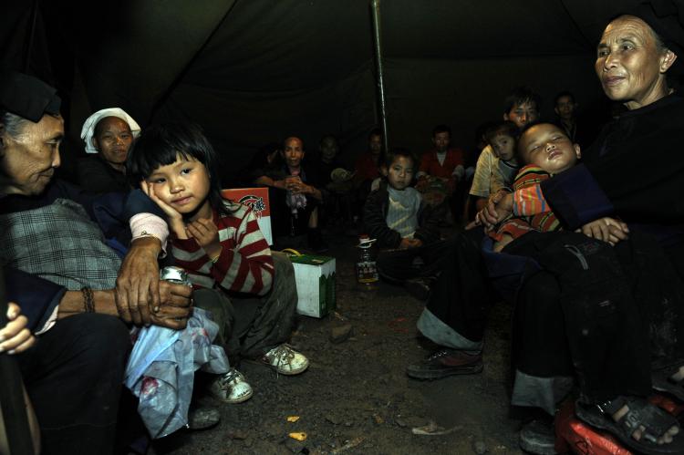 Villagers from a neighboring village where mudslide hits stay in a tent after evacuating from their homes. (The Epoch Times Archive ) Villagers from a neighboring village where mudslide hits stay in a tent after evacuating from their homes. (The Epoch Times Archive )