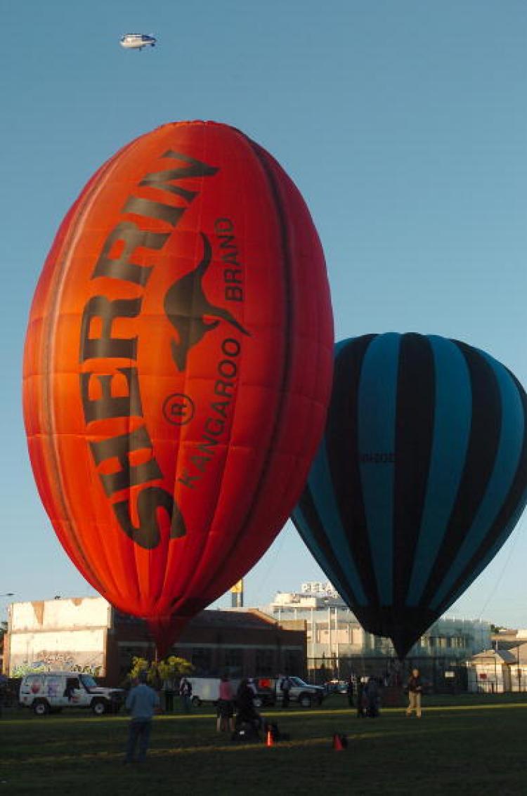 A giant Australian Rules Football-shaped ballon is lit up by the rising sun during celebrations marking the 150th anniversary of the first Australian balloon flight in Melbourne. (Paul Crock/AFP/Getty Images) A giant Australian Rules Football-shaped ballon is lit up by the rising sun during celebrations marking the 150th anniversary of the first Australian balloon flight in Melbourne. (Paul Crock/AFP/Getty Images)