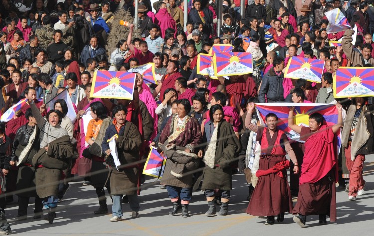 In this picture taken on March 14, 2008, protesters led by Tibetan Buddhist monks shout slogans and carry the Tibetan national flag near Labrang monastery in Gansu Province. Another Tibetan set themselves on fire earlier this week near Labrang in a protest against Chinese rule.  (Mark Ralson/AFP/Getty Images)