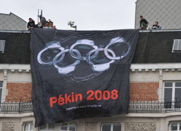 Reporters Without Borders replaced the rings in the traditional Olympics logo with handcuffs as part of a campaign to call for a boycott of the Beijing Olympic Games. (Dominique Faget/AFP/Getty Images))
