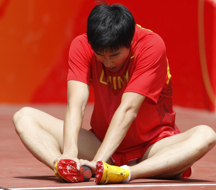 China's Liu Xiang retires from the first round of the men's 110m hurdles at the 'Bird's Nest' National Stadium during the 2008 Beijing Olympic Games. (Adrian Dennis/AFP/Getty Images) China's Liu Xiang retires from the first round of the men's 110m hurdles at the 'Bird's Nest' National Stadium during the 2008 Beijing Olympic Games. (Adrian Dennis/AFP/Getty Images)