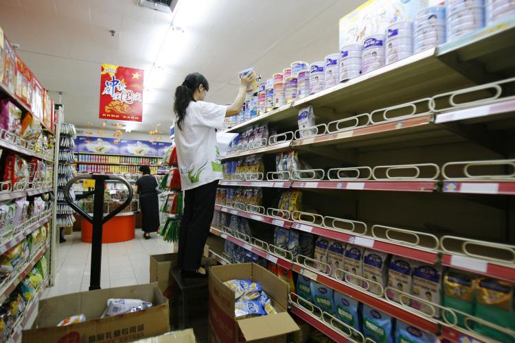 A worker removes melamine-tainted milk powder from the shelf in a supermarket in September in Beijing, China. All the major brands are affected. (China Photos/Getty Images) A worker removes melamine-tainted milk powder from the shelf in a supermarket in September in Beijing, China. All the major brands are affected. (China Photos/Getty Images)