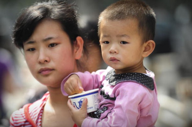 A mother leaves a children's hospital with her child in Beijing on September 22, 2008 as China's toxic milk scandal escalated after officials admitted nearly 53,000 children had been sickened by contaminated products and more countries moved to ban or lim (Peter Parks/AFP/Getty Images) A mother leaves a children's hospital with her child in Beijing on September 22, 2008 as China's toxic milk scandal escalated after officials admitted nearly 53,000 children had been sickened by contaminated products and more countries moved to ban or lim (Peter Parks/AFP/Getty Images)