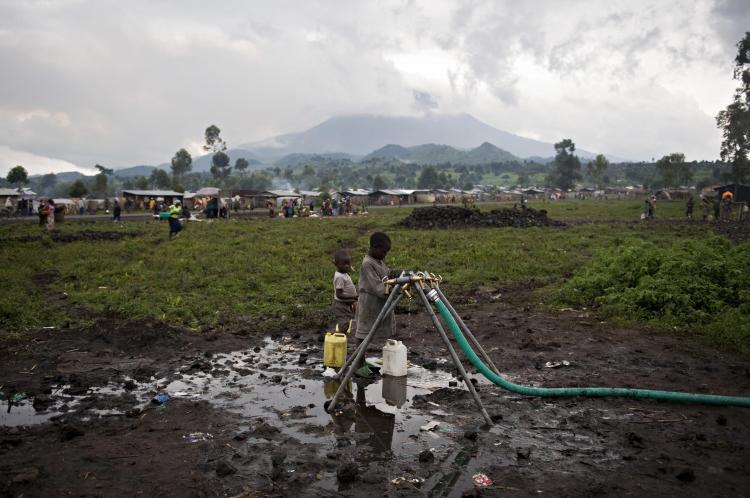 People, who have been displaced by violence in the  Democratic Republic of Congo, get water on January 28, 2009 in their camp for internally displaced people. (Walter Astrada/AFP/Getty Images)