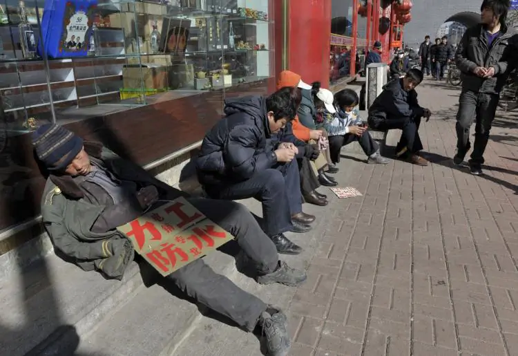 Migrant workers look for job opportunities along a roadside in Shenyang, Liaoning Province, China, on September 30, 2015. (China Photos/Getty Images)