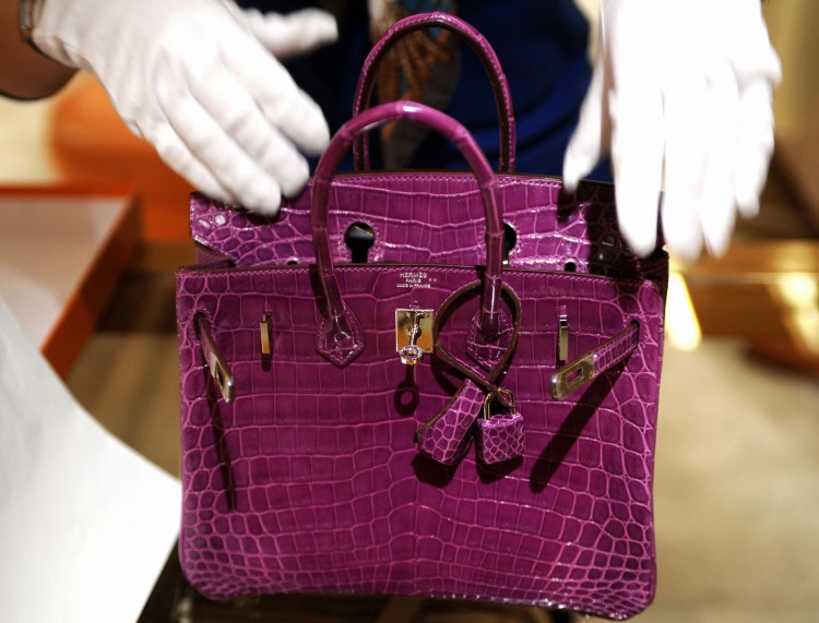 A woman inspects a Hermes crocodile skin bag. (Sam Yeh/AFP/Getty Images) A woman inspects a Hermes crocodile skin bag. (Sam Yeh/AFP/Getty Images)