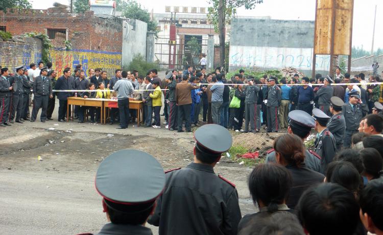 Chinese security guards surround the entrance to a mine as family members arrive to find out the fate of the miners, following a gas explosion in Pingdingshan, central China's Henan province on September 8, 2009. (AFP/Getty Images) Chinese security guards surround the entrance to a mine as family members arrive to find out the fate of the miners, following a gas explosion in Pingdingshan, central China's Henan province on September 8, 2009. (AFP/Getty Images)