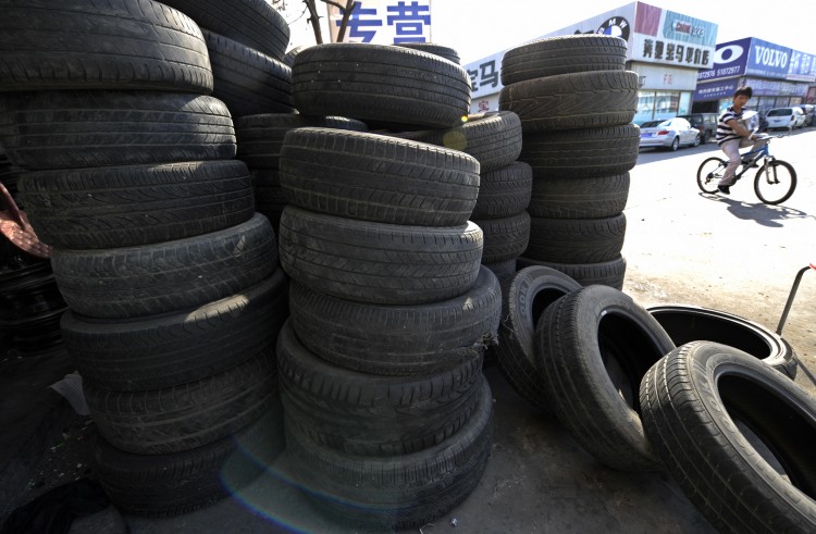 A man rides a bicycle past tires on display at a shop in Beijing on September 15, 2009. (Liu Jin/AFP/Getty Images) A man rides a bicycle past tires on display at a shop in Beijing on September 15, 2009. (Liu Jin/AFP/Getty Images)