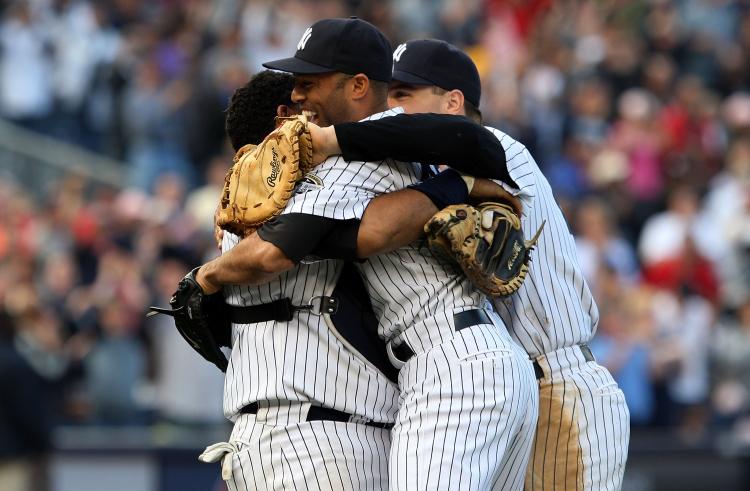 DIVISION CHAMPS: Mariano Rivera, Jose Molina, and Mark Teixeira celebrate after defeating Boston and clinching the AL East. (Jim McIsaac/Getty Images) DIVISION CHAMPS: Mariano Rivera, Jose Molina, and Mark Teixeira celebrate after defeating Boston and clinching the AL East. (Jim McIsaac/Getty Images)