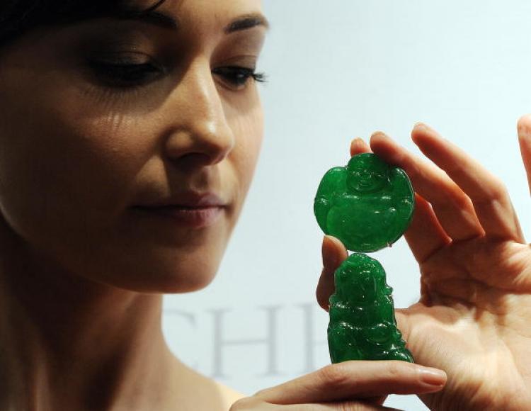 A carved jadeite Milefo valued between 770,000 to 1 million US dollars and a jadeite Guanyin in Hong Kong. (Mike Clarke/AFP/Getty Images) A carved jadeite Milefo valued between 770,000 to 1 million US dollars and a jadeite Guanyin in Hong Kong. (Mike Clarke/AFP/Getty Images)