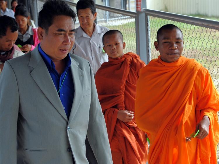 Cambodian Reach Sambath, Chief of the Public Affairs section of the Extraordinary Chambers in the Courts of Cambodia (ECCC), guides monks to attend the trial of former Khmer Rouge prison chief, Kaing Guek Eav (Duch), in Phnom Penh on November 27, 2009. (Tang Chhin Sothy/AFP/Getty Images) Cambodian Reach Sambath, Chief of the Public Affairs section of the Extraordinary Chambers in the Courts of Cambodia (ECCC), guides monks to attend the trial of former Khmer Rouge prison chief, Kaing Guek Eav (Duch), in Phnom Penh on November 27, 2009. (Tang Chhin Sothy/AFP/Getty Images)