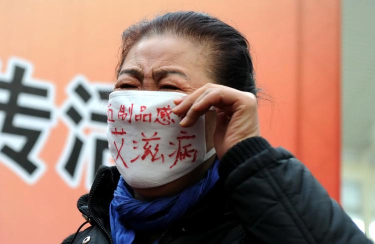 A woman who contracted HIV from infected blood joins a demonstration during an AIDS awareness event on World AIDS Day at Beijing's south railway station in 2009. (AFP/Getty Images) A woman who contracted HIV from infected blood joins a demonstration during an AIDS awareness event on World AIDS Day at Beijing's south railway station in 2009. (AFP/Getty Images)