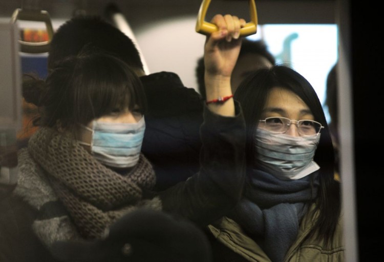 Two women wear masks while riding on the Two women wear masks while riding on the Beijing subway. (Peter Parks/AFP/Getty Images)