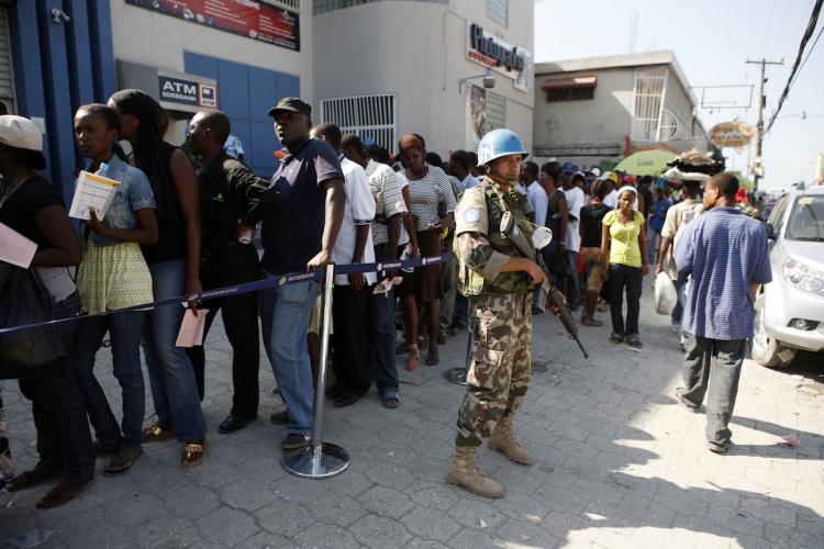 Nepalese UN Peacekeepers provide security as Haitians stand in line at a bank branch waiting for it to open January 23, in Port-au-Prince, Haiti. (Sophia Paris/Getty Images ) Nepalese UN Peacekeepers provide security as Haitians stand in line at a bank branch waiting for it to open January 23, in Port-au-Prince, Haiti. (Sophia Paris/Getty Images )