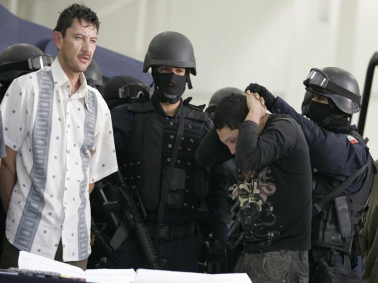 Alleged drugdealers of the 'El Chiquilin' gang of the Sinaloa Cartel are escorted by policemen during their presentation by the Federal Police in Mexico City on February 9, 2010, following their arrest in La Paz, Baja Calfornia state, Mexico. (STR/AFP/Getty Images) Alleged drugdealers of the 'El Chiquilin' gang of the Sinaloa Cartel are escorted by policemen during their presentation by the Federal Police in Mexico City on February 9, 2010, following their arrest in La Paz, Baja Calfornia state, Mexico. (STR/AFP/Getty Images)