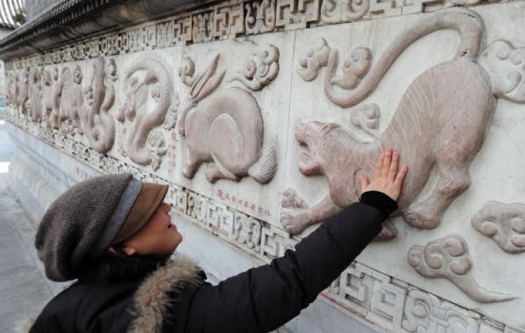 A bas relief sculpture of a tiger along a wall of bas relief sculptures depicting the 12 animals of the Chinese zodiac at the White Cloud Temple in Beijing. (Frederic J. Brown/AFP/Getty Images) A bas relief sculpture of a tiger along a wall of bas relief sculptures depicting the 12 animals of the Chinese zodiac at the White Cloud Temple in Beijing. (Frederic J. Brown/AFP/Getty Images)