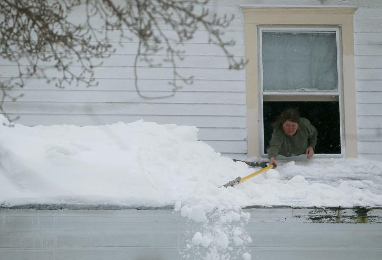 Peggy Grace pushes snow off of her roof on February 10, 2010 in Owings, MD. (Mark Wilson/Getty Images) Peggy Grace pushes snow off of her roof on February 10, 2010 in Owings, MD. (Mark Wilson/Getty Images)
