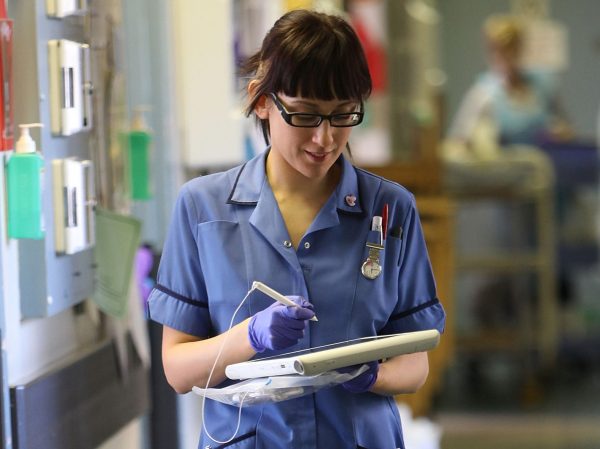 A nurse uses a wireless electronic tablet to order medicines from the pharmacy at The Queen Elizabeth Hospital in Birmingham. (Christopher Furlong/Getty Images)