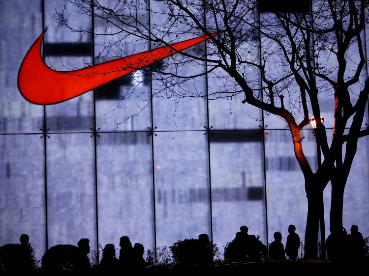 Shanghai residents pass by a Nike store on the Nanjing Road shopping street on April 17, 2010 in Shanghai. Today, 41 percent of Nike's shoes are manufactured in Vietnam, and 32 percent are made in China. (Feng Li/Getty Images)