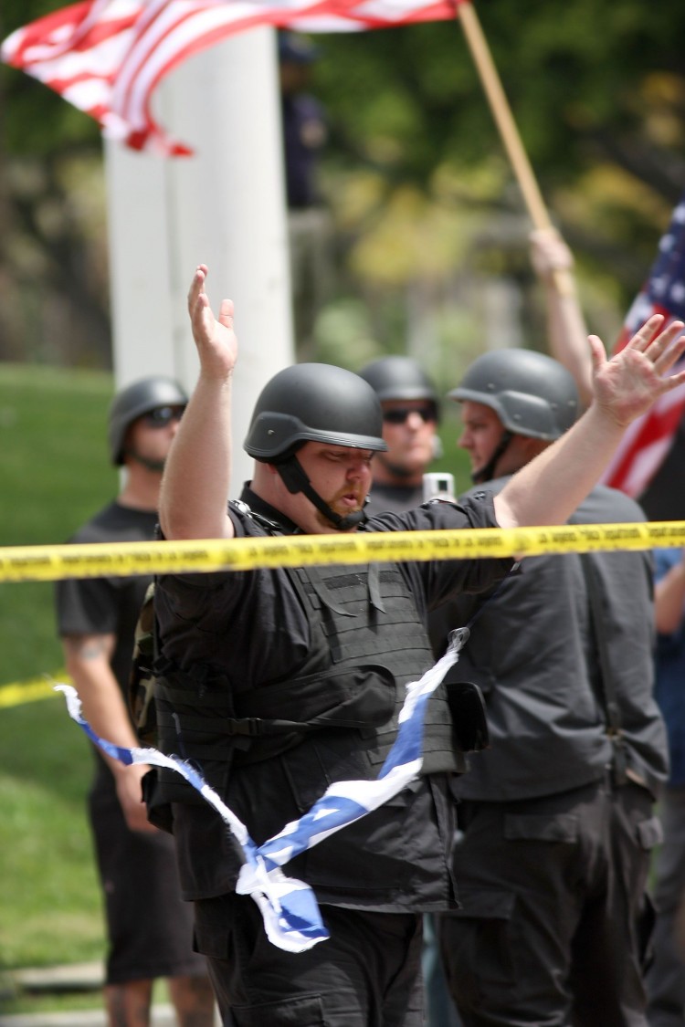 A member of the neo-Nazi group National Socialist Movement raises his arms after ripping up a flag of Israel during a rally on April 17, 2010, in Los Angeles. Hate crimes in Canada rose significantly in 2009, according to a Statistics Canada report. (David McNew/Getty Images) A member of the neo-Nazi group National Socialist Movement raises his arms after ripping up a flag of Israel during a rally on April 17, 2010, in Los Angeles. Hate crimes in Canada rose significantly in 2009, according to a Statistics Canada report. (David McNew/Getty Images)