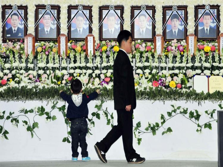 Two sons of the late Master Chief Petty Officer Nam Ki-Hoon visit a mourning altar at a naval base in Pyeongtaek on April 27, set up to pay tribute to sailors killed in the March 26 sinking of the warship PCC-772 Cheonan near the disputed border with Nort (Korea Pool/AFP/Getty Images) Two sons of the late Master Chief Petty Officer Nam Ki-Hoon visit a mourning altar at a naval base in Pyeongtaek on April 27, set up to pay tribute to sailors killed in the March 26 sinking of the warship PCC-772 Cheonan near the disputed border with Nort (Korea Pool/AFP/Getty Images)