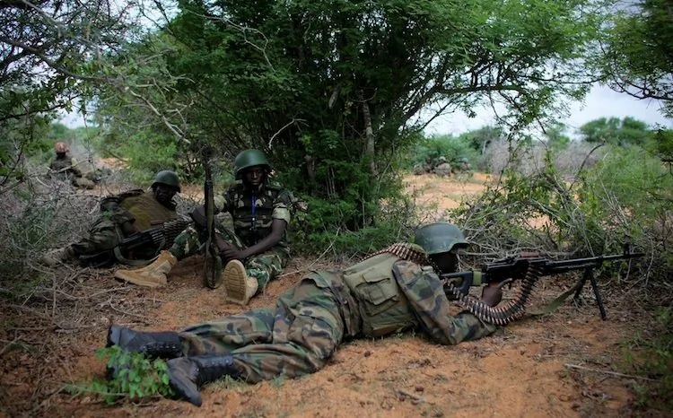 In this handout photograph released by the African Union-United Nations Support Team, soldiers take up a defensive position during a firefight on May 22, operation to seize and liberate territory from the Al-Qaeda-affiliated extremist group Al Shabaab. (Stuart Price/AFP/GettyImages) 