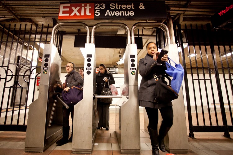 Amal+Chen-20111214-IMG_4924- Commuters at the 23rd Street and Fifth Avenue station pass through turnstiles last winter. (Amal Chen/The Epoch Times) Commuters at the 23rd Street and Fifth Avenue station pass through turnstiles last winter. (Amal Chen/The Epoch Times)