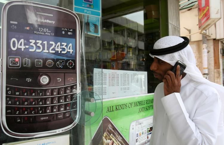 A man walks past a sign advertising the BlackBerry mobile phone at a shopping mall in Dubai on August 01. As the Gulf business hub stated it will suspend key BlackBerry services from October because they are incompatible with local laws and raise security concerns.(STR/Getty Images)