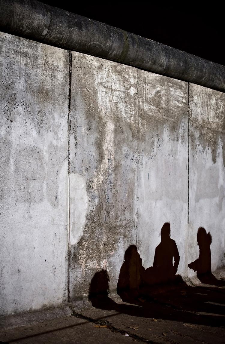 The shadows from a group of tourists are cast onto an original section of the Berlin Wall in Bernauer Strasse, central Berlin, on Nov. 8.  (Leon Neal/AFP/Getty Images)