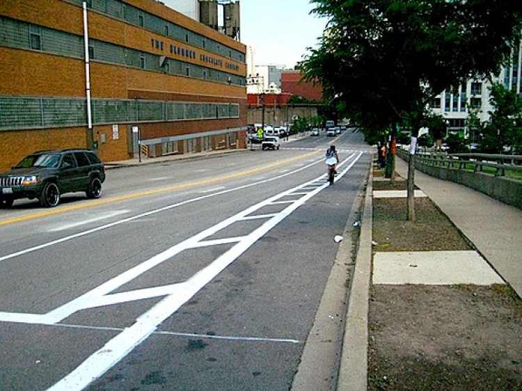 Kinzie Street near Desplaines Street, an example of a bike lane protected by 4 feet of buffer area, and a lane for parking. (Courtesy of Chicago Department of Transportation) Kinzie Street near Desplaines Street, an example of a bike lane protected by 4 feet of buffer area, and a lane for parking. (Courtesy of Chicago Department of Transportation)