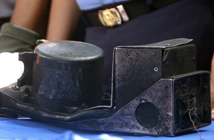 The charred cockpit voice recorder of the Russian Sukhoi Superjet 100 is seen on a table during a turnover ceremony to the Indonesian investigating body at the search and rescue base in Cijeruk on May 16. (AFP/AFP/GettyImages) Epoch Times Photo