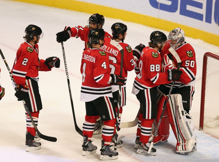 Minneosta Wild v Chicago Blackhawks The Chicago Blackhawks congratulate goalie Corey Crawford after beating the Minnesota Wild Tuesday night. (Jonathan Daniel/Getty Images)