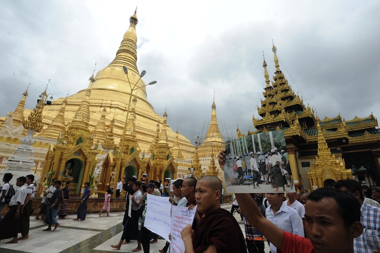 Rakhine Buddhist monks and demonstrators hold banners and pictures as they gather at the Shwedagon pagoda after unrest flared in the western Myanmar state and at least seven people were killed, in Yangon on June 10. (Soe Than Win/AFP/GettyImages). Epoch Times Photo