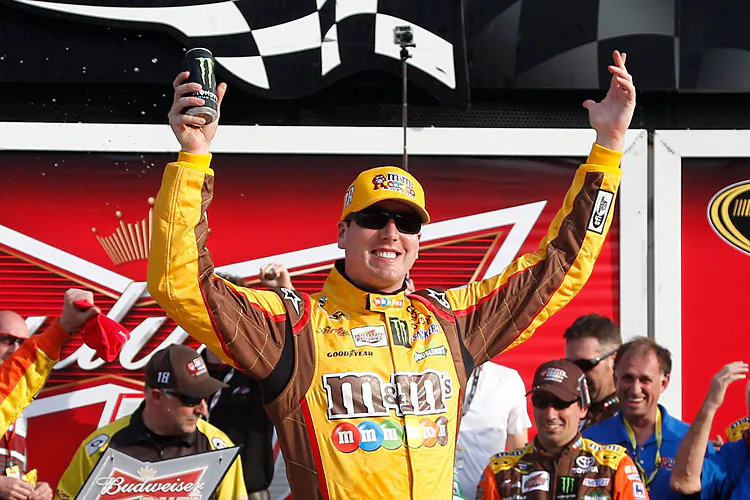 Kyle Busch, driver of the M&M's Toyota, celebrates in Victory Lane after winning the NASCAR Sprint Cup Series Budweiser Duel 2 at Daytona International Speedway in Daytona Beach, Fla., on Feb. 21, 2013. (Chris Graythen/Getty Images)