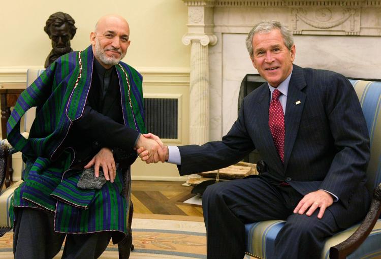 OVAL OFFICE: President George W. Bush (R) shakes hands with Afghan President Hamid Karzai (L) during their meeting in the Oval Office of the White House Sept. 26 in Washington, DC. (Alex Wong/Getty Images) OVAL OFFICE: President George W. Bush (R) shakes hands with Afghan President Hamid Karzai (L) during their meeting in the Oval Office of the White House Sept. 26 in Washington, DC. (Alex Wong/Getty Images)