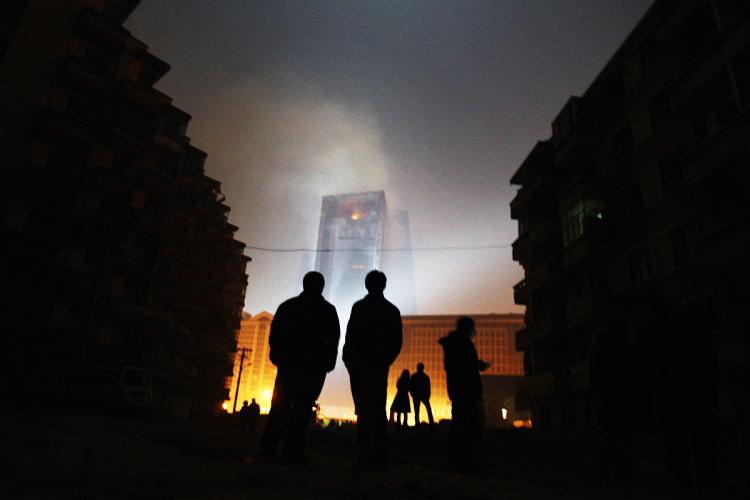 TOWER BURNS: People watch a fire at the unfinished The Mandarin Oriental hotel, that is part of complex that houses the Chinese Central Television's (CCTV) headquarters on February 9, 2008 in Beijing, China. (Feng Li/Getty Images)