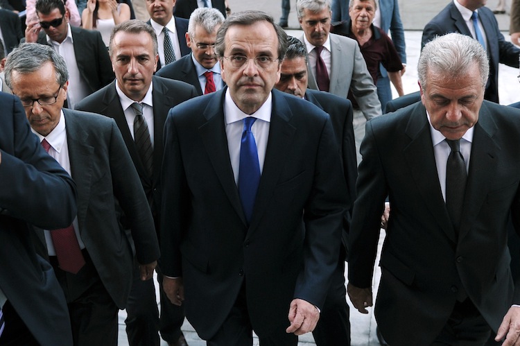 Greece's new Prime Minister Antonis Samaras and Foreign minister Dimitris Avramopoulos (R), flanked by security and newly appointed ministers, arrive at the Greek parliament for their first cabinet meeting on June 21. (Louisa Gouliamaki/AFP/GettyImages) Epoch Times Photo